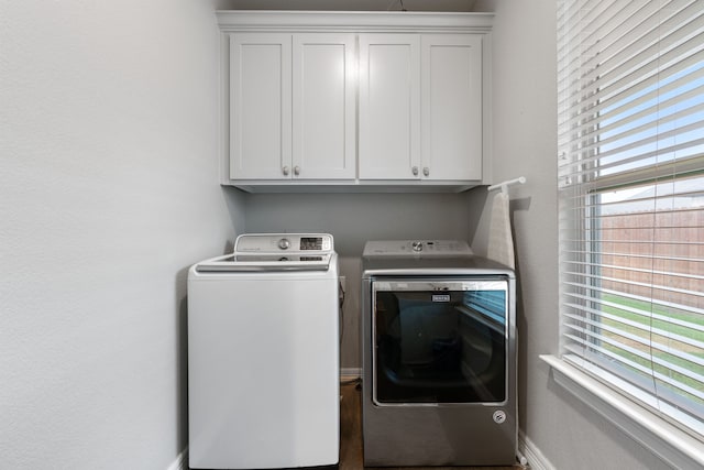 washroom featuring cabinets and separate washer and dryer