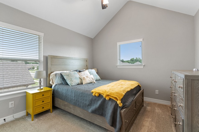 carpeted bedroom with ceiling fan and vaulted ceiling