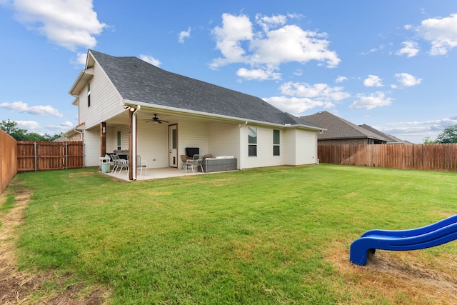 back of house with an outdoor living space, ceiling fan, a yard, and a patio