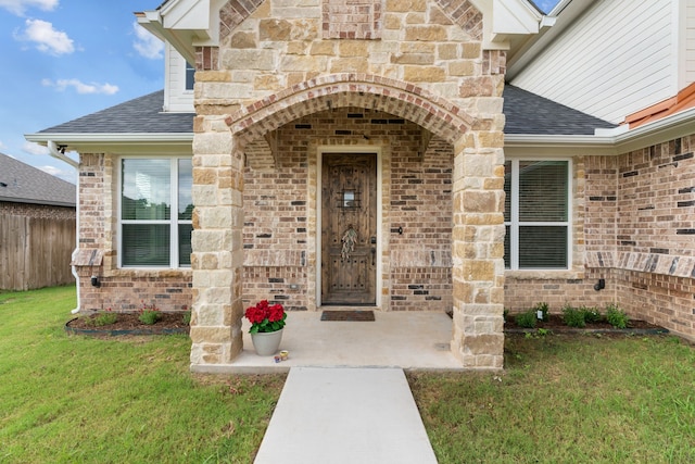 doorway to property with a lawn