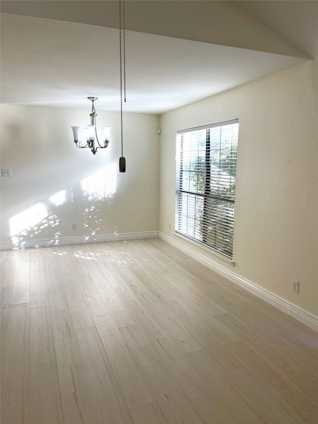 interior space featuring a chandelier and light wood-type flooring