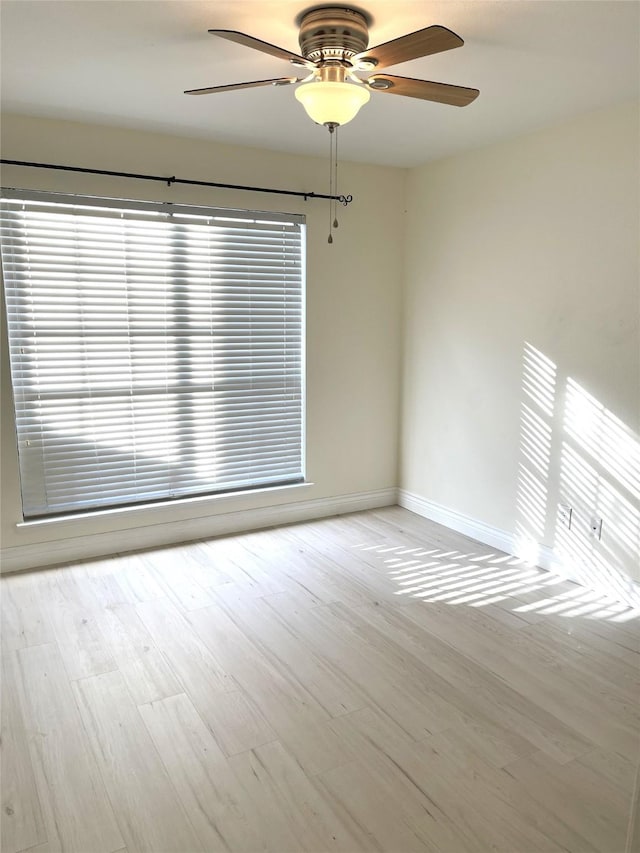 empty room featuring light hardwood / wood-style flooring and ceiling fan