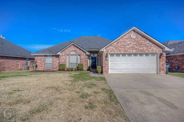 view of front of home featuring a front yard, a garage, and central AC unit