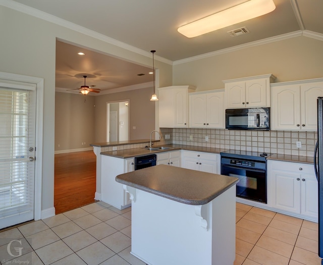 kitchen with kitchen peninsula, crown molding, black appliances, white cabinetry, and hanging light fixtures