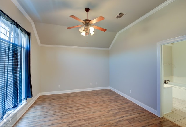 additional living space with ceiling fan, lofted ceiling, and light wood-type flooring