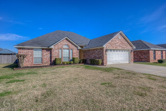 view of front of home with a garage and a front lawn