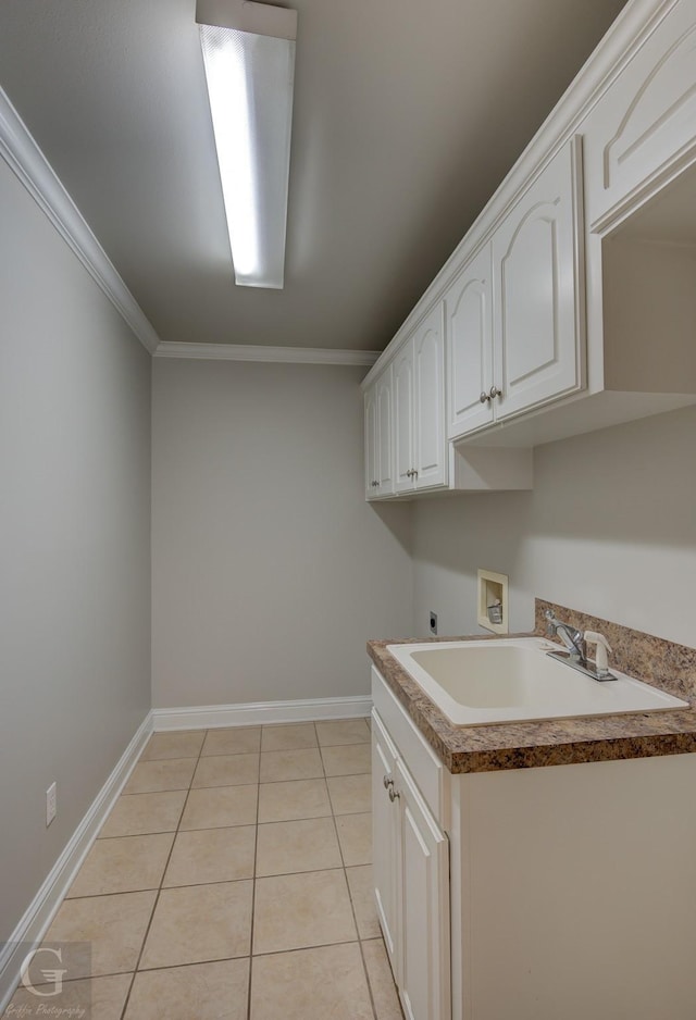 laundry area featuring crown molding, sink, washer hookup, hookup for an electric dryer, and light tile patterned flooring