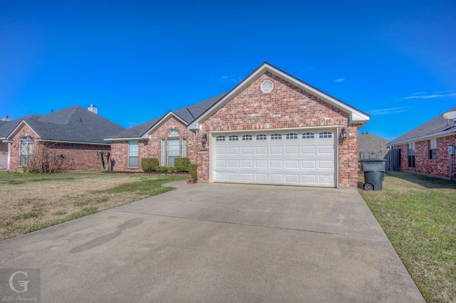 view of front of property with a garage and a front yard