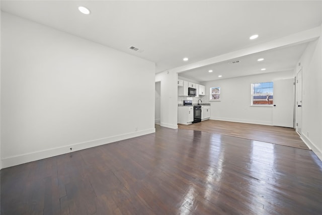 unfurnished living room with hardwood / wood-style flooring