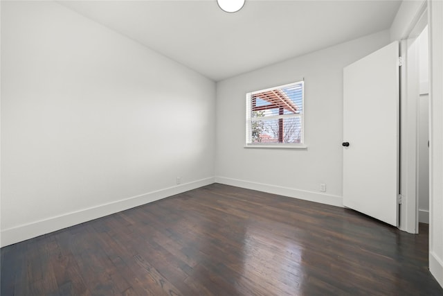 empty room with dark hardwood / wood-style floors