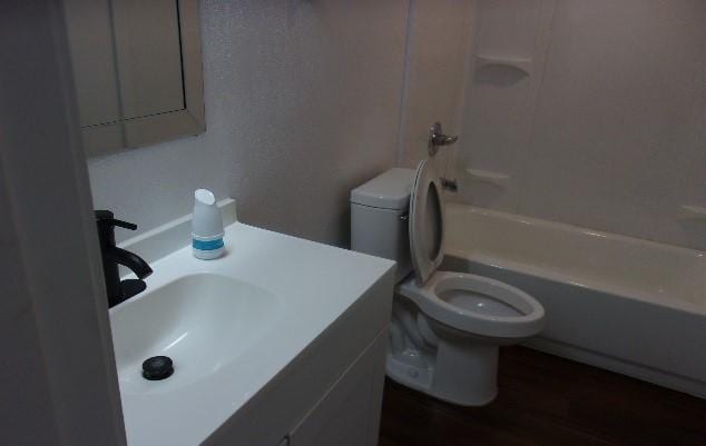 full bathroom with vanity, bathtub / shower combination, and toilet