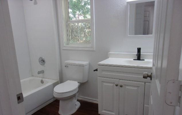 full bathroom featuring hardwood / wood-style floors, vanity, toilet, and shower / washtub combination