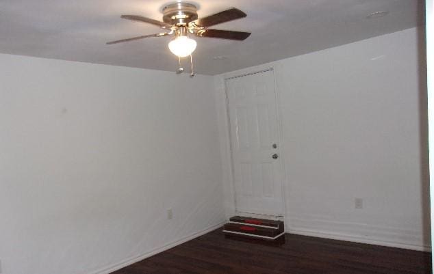 spare room featuring ceiling fan and dark hardwood / wood-style flooring