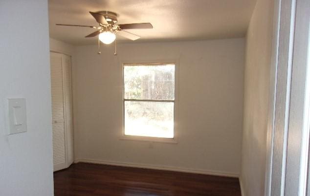 empty room featuring dark hardwood / wood-style floors and ceiling fan