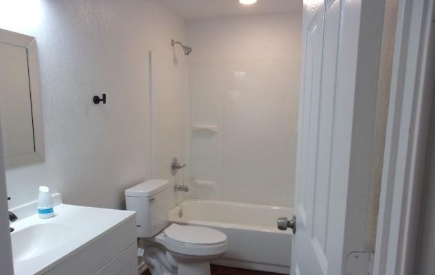 full bathroom with vanity, toilet, and shower / bathtub combination