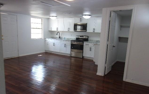 kitchen featuring sink, white cabinets, dark hardwood / wood-style floors, and appliances with stainless steel finishes