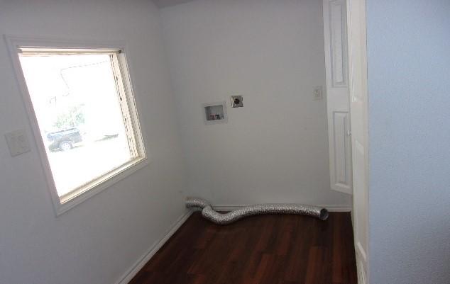 washroom with electric dryer hookup, dark hardwood / wood-style flooring, and hookup for a washing machine