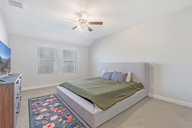 bedroom with vaulted ceiling, ceiling fan, and light colored carpet