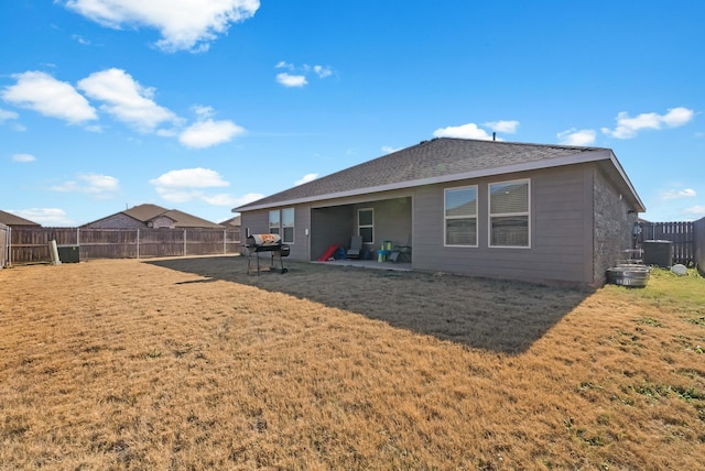 back of property featuring a patio area and a lawn