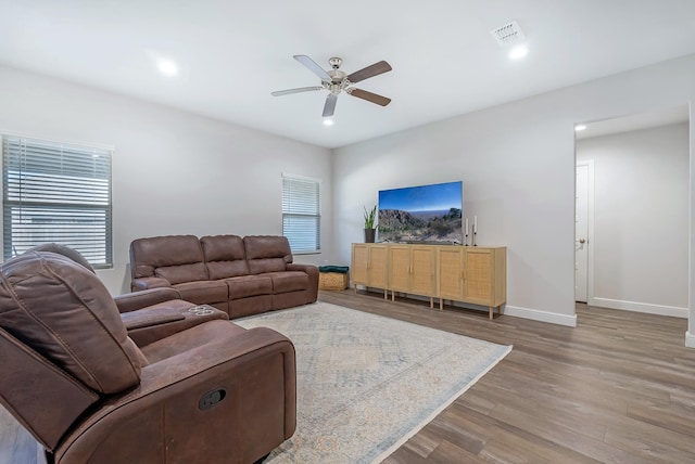 living room with hardwood / wood-style flooring and ceiling fan