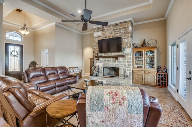 kitchen with light stone countertops, crown molding, a kitchen island with sink, and a breakfast bar area