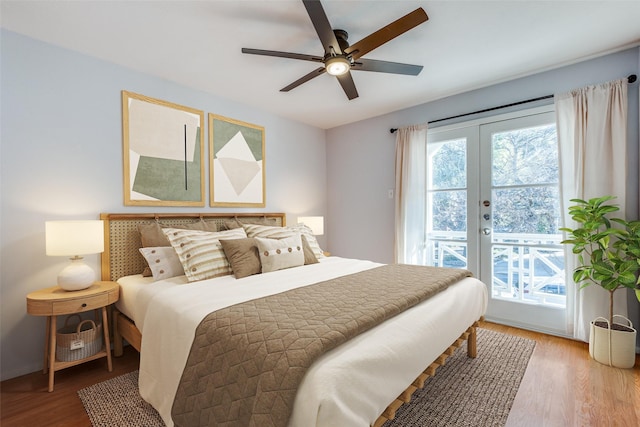 bedroom featuring access to exterior, french doors, hardwood / wood-style flooring, and ceiling fan