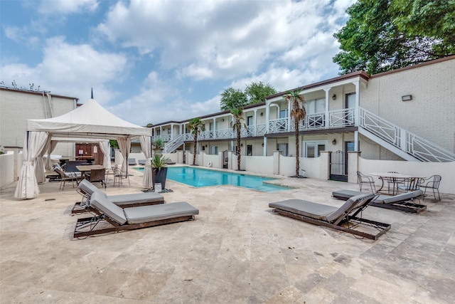 view of swimming pool featuring a gazebo and a patio