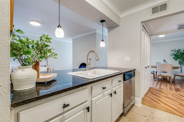 kitchen featuring pendant lighting, white cabinets, crown molding, sink, and stainless steel dishwasher