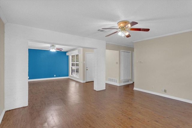 unfurnished room with ceiling fan, crown molding, a textured ceiling, and dark wood-type flooring