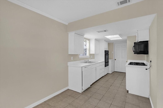 kitchen with white cabinets, light tile patterned floors, sink, and black appliances