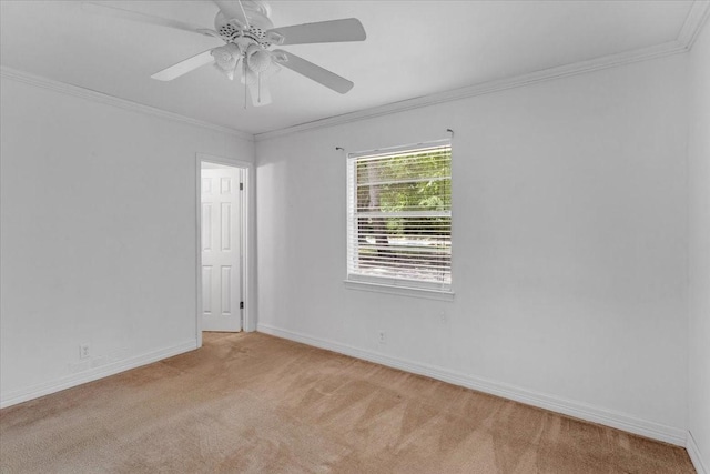 empty room featuring ceiling fan, light colored carpet, and ornamental molding