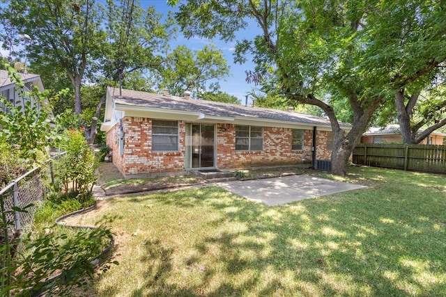 back of property featuring a patio area and a lawn