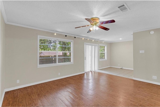 unfurnished room featuring ceiling fan, light hardwood / wood-style floors, ornamental molding, and rail lighting