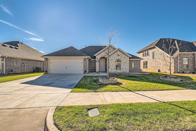 view of front of house with a front yard, central AC, and a garage