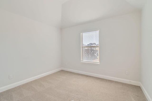 unfurnished room featuring light colored carpet