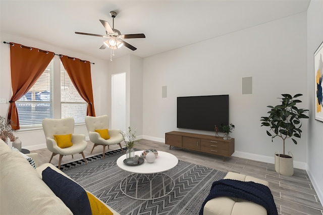 living room with ceiling fan and light hardwood / wood-style floors