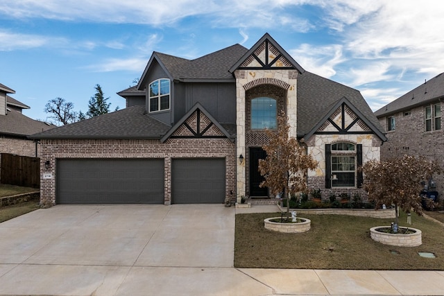 view of front of home featuring brick siding, driveway, a shingled roof, and an attached garage