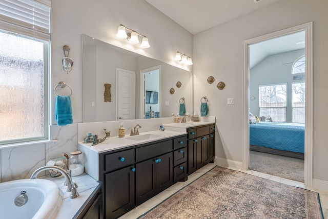 bathroom featuring tile patterned floors, vanity, and a healthy amount of sunlight