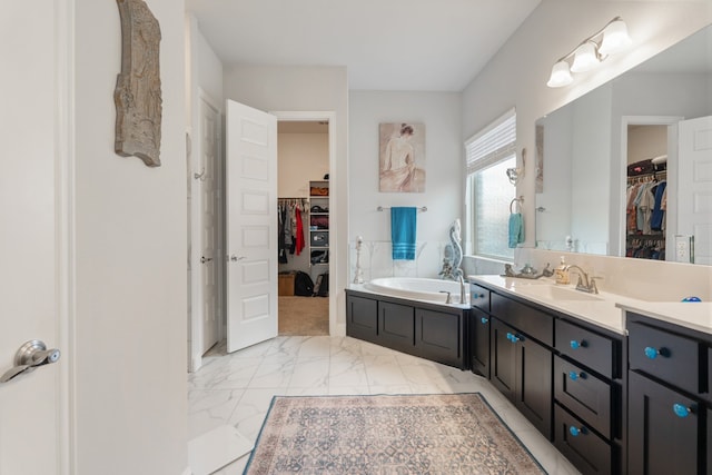 bathroom with a washtub and vanity