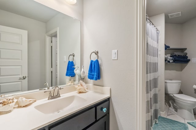 bathroom featuring curtained shower, vanity, and toilet