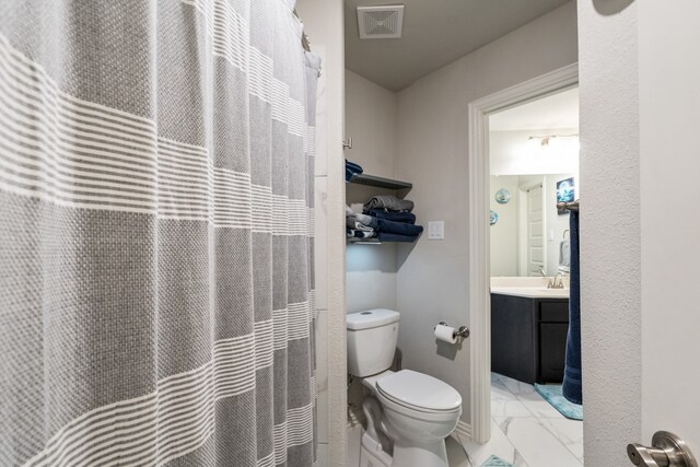 bathroom featuring vanity and toilet