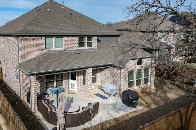 back of property with a jacuzzi