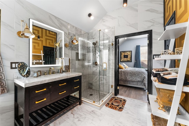 bathroom featuring an enclosed shower, vanity, tile walls, and lofted ceiling