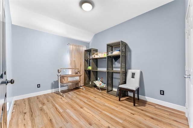 living area featuring lofted ceiling and light wood-type flooring