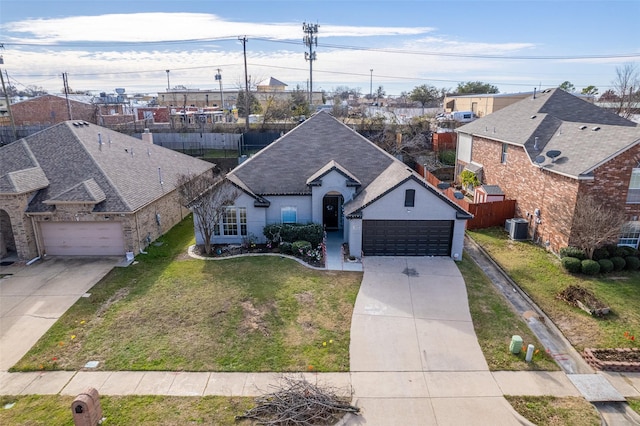 view of front facade featuring central AC, a front lawn, and a garage