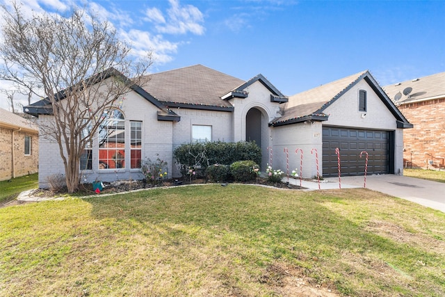 view of front of property with a front yard and a garage