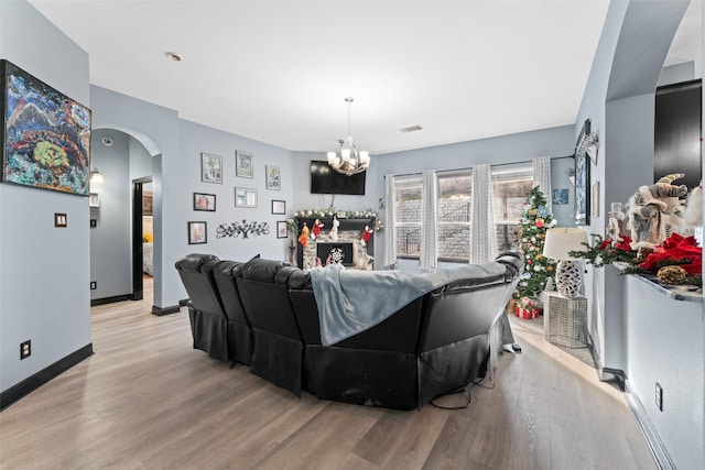 living room featuring a chandelier and light hardwood / wood-style floors