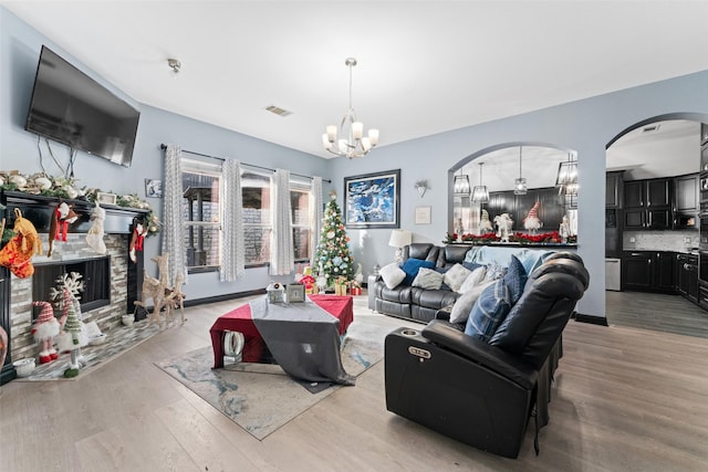 living room featuring light hardwood / wood-style flooring and an inviting chandelier