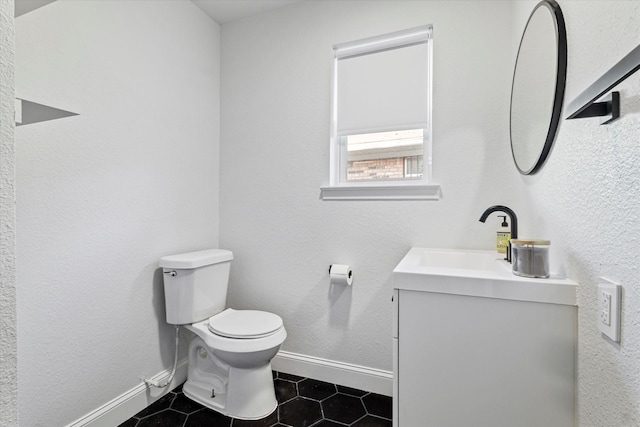 bathroom featuring tile patterned flooring, vanity, and toilet