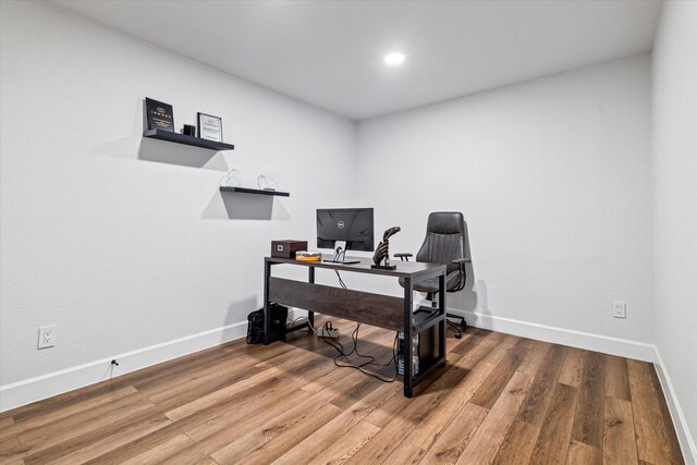 home office with hardwood / wood-style flooring